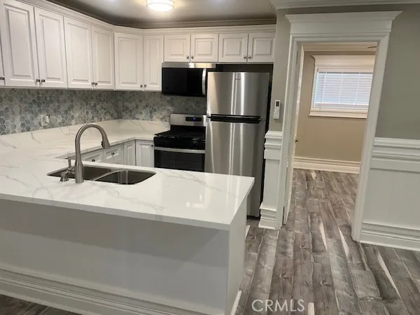 a kitchen with a refrigerator and a sink