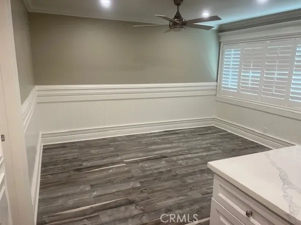 a view of a room with an empty space and windows