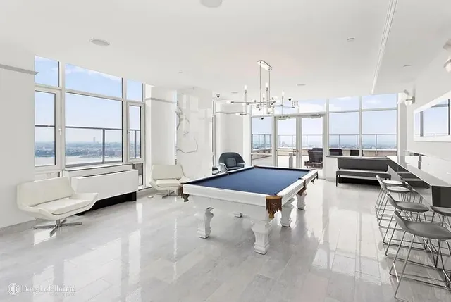 a dining table chairs and a stove in a room
