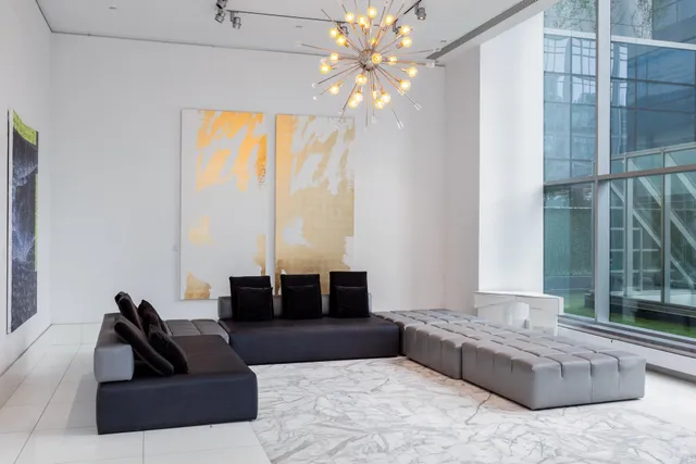 a living room with furniture and a chandelier