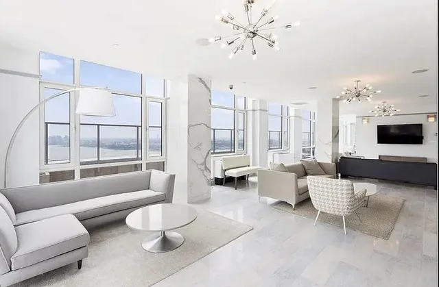 a living room with furniture a table and chairs