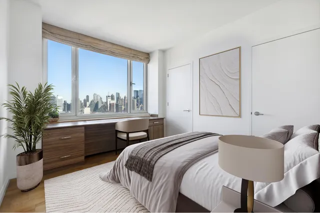 a bedroom with a large bed and a window