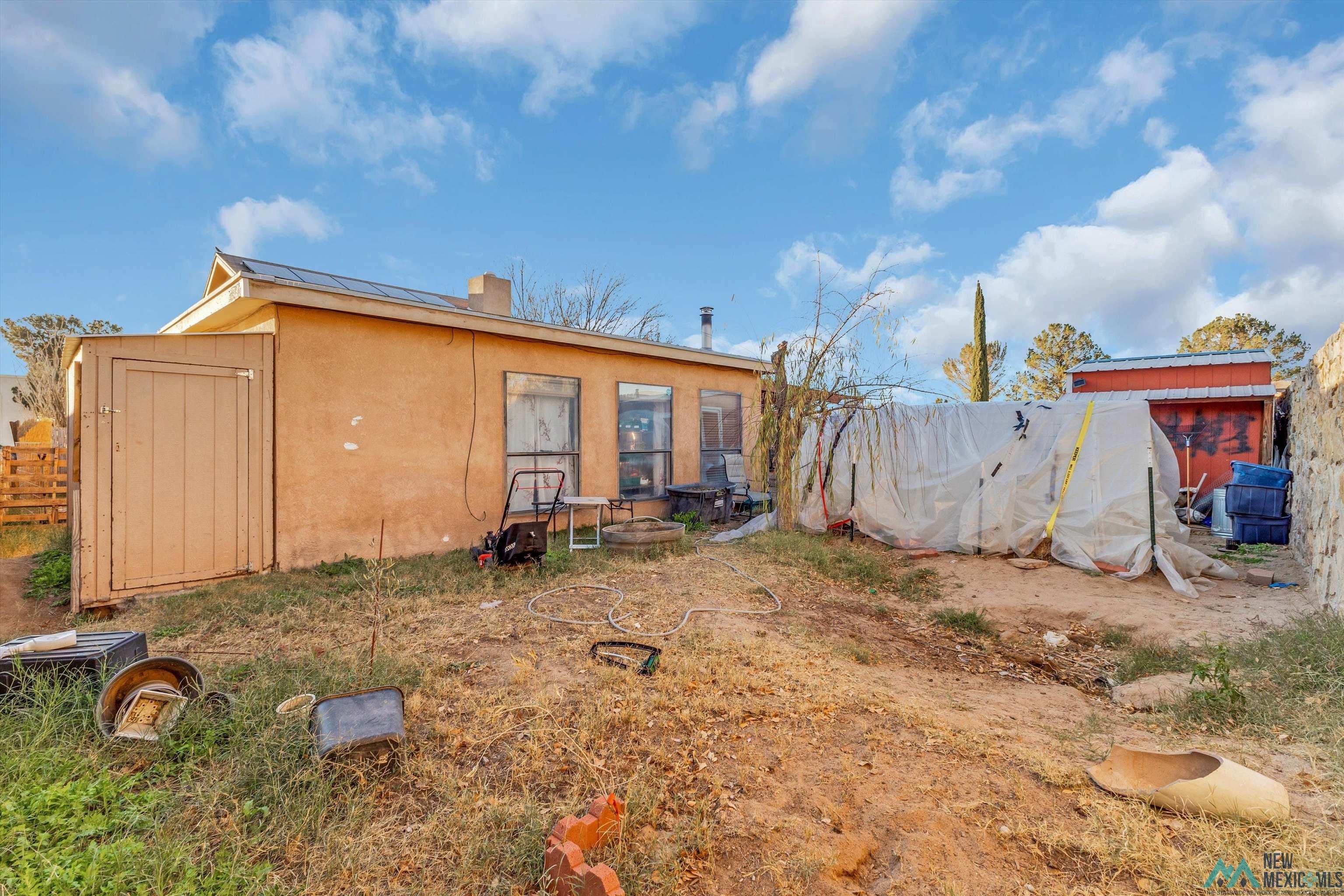5008 Shadow Road Las Cruces, NM 88011 - Photo 33 of 35 Rear view of house with a shed and stucco siding