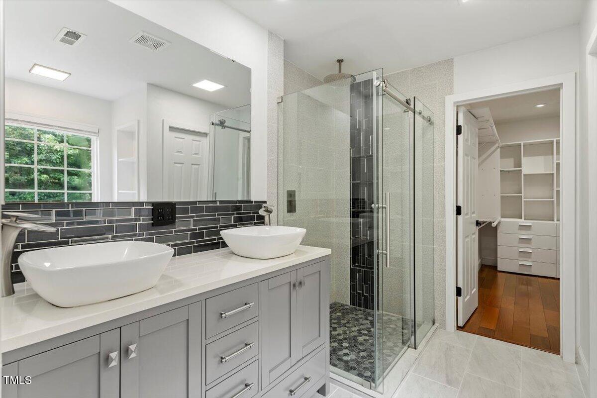 7414 Brandon Allen Avenue Raleigh, NC 27613 - Photo 29 of 57 a bathroom with a double vanity sink mirror and shower