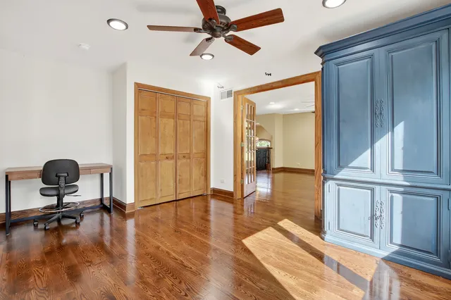 a living room with lots of wooden furniture and windows
