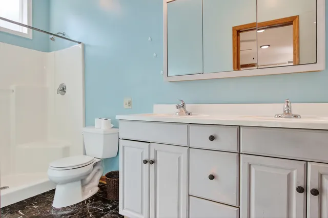 a large kitchen with stainless steel appliances granite countertop a stove and a sink