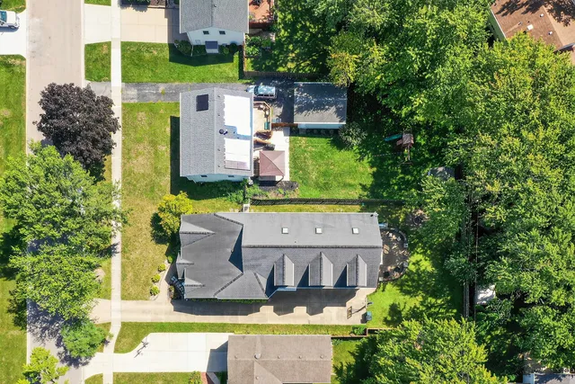 an aerial view of a house with yard swimming pool and outdoor seating