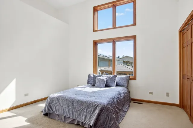 a living room with furniture a flat screen tv and a window