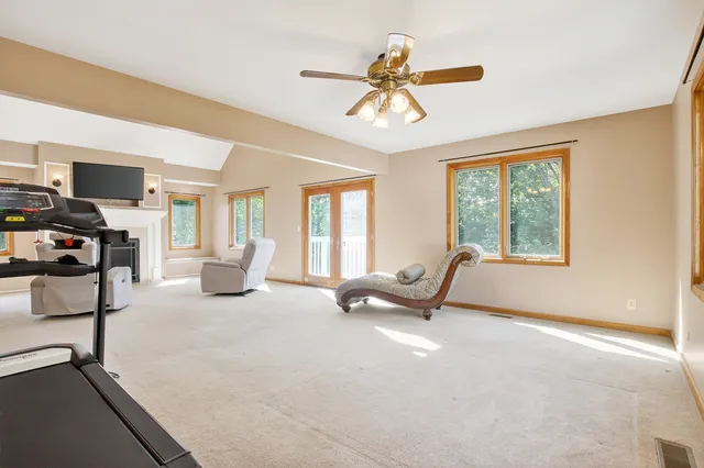 a spacious bedroom with a large dresser and a flat screen tv