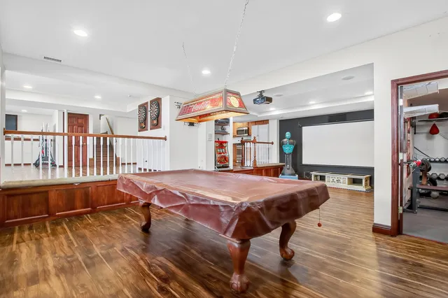 an aerial view of residential houses with outdoor space and trees all around