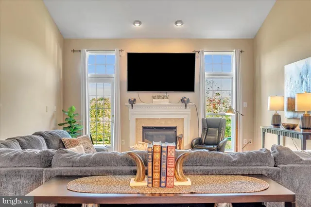 a living room with fireplace furniture a flat screen tv and a fireplace