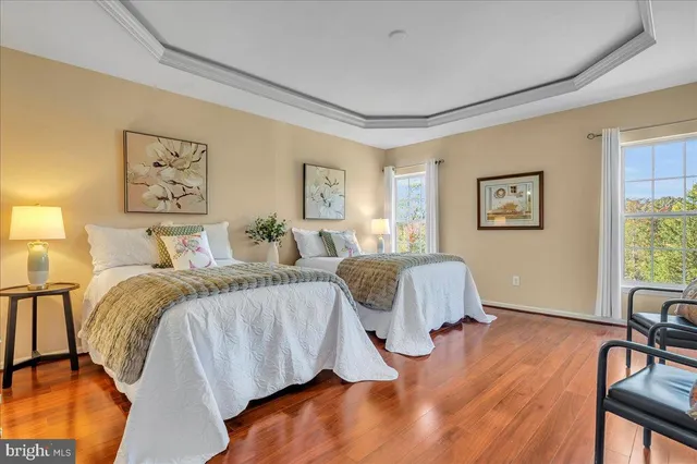 a bedroom with two beds and painting on the wall