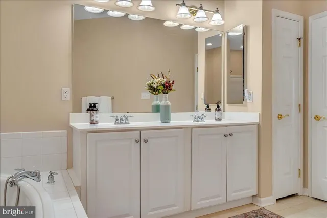 a bathroom with a sink vanity and a mirror