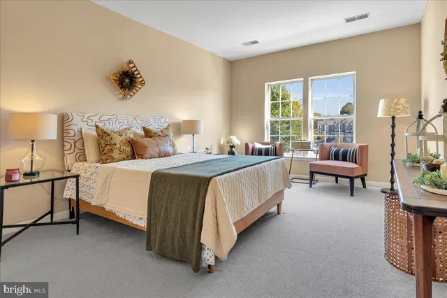 a spacious bedroom with a bed and a couch