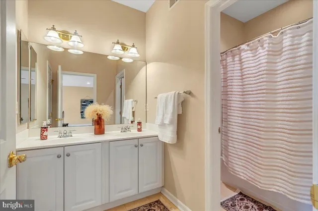 a bathroom with a double vanity sink and a mirror