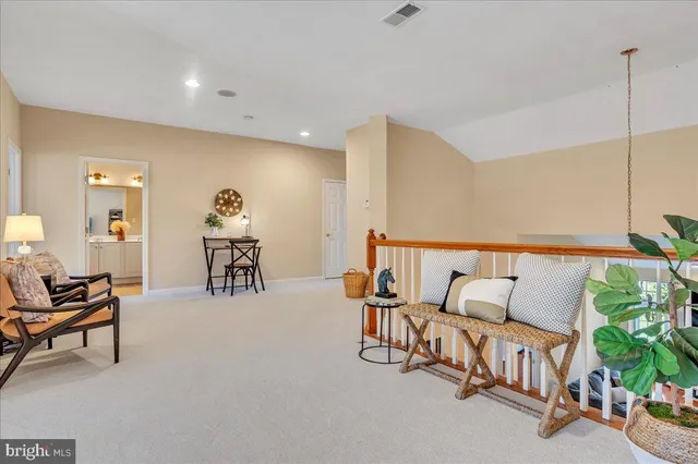 a living room with furniture and a potted plant