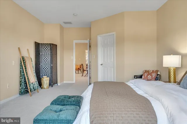 a bedroom with a bed and a couch