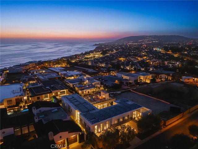 an aerial view of residential houses with city view