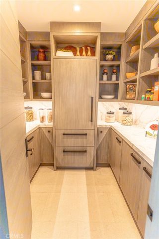 a room with white cabinets and sink