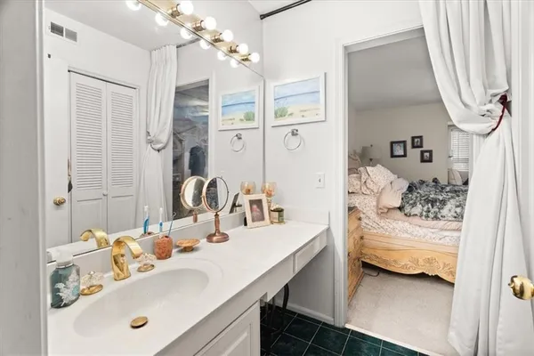 a bathroom with a sink vanity and a mirror