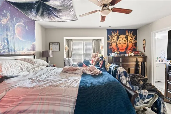 a bedroom with furniture and a large window