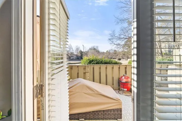 a view of a balcony with a table and chairs and wooden floor