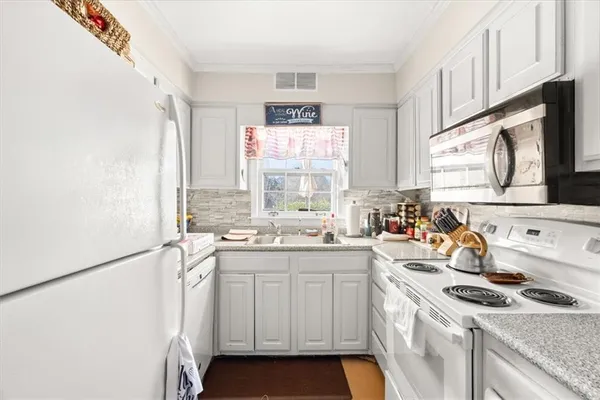 a kitchen with a sink stove and cabinets