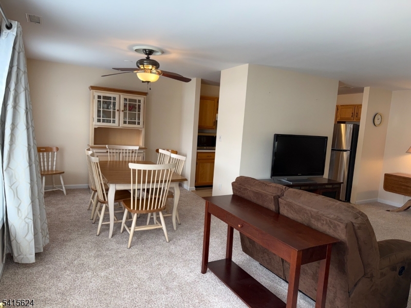 5 Chanda Court, Unit 5 Clifton, NJ 07012 - Photo 2 of 15 a bedroom with furniture and a flat screen tv