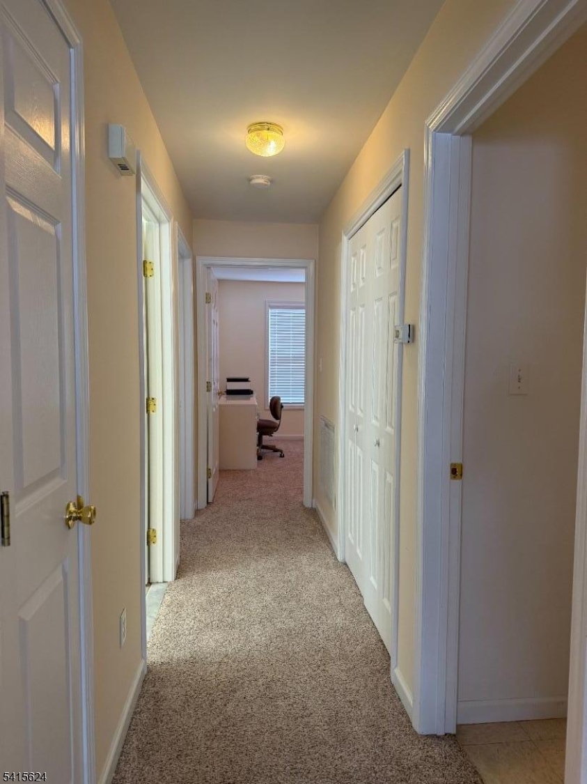 5 Chanda Court, Unit 5 Clifton, NJ 07012 - Photo 7 of 15 a view of a hallway with a livingroom and a space window