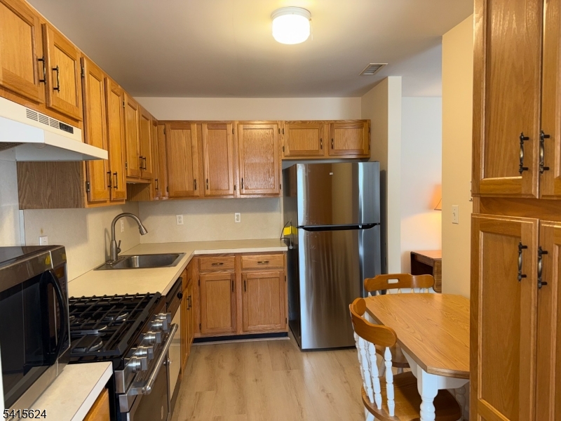 5 Chanda Court, Unit 5 Clifton, NJ 07012 - Photo 8 of 15 a kitchen with stainless steel appliances granite countertop a refrigerator stove and sink