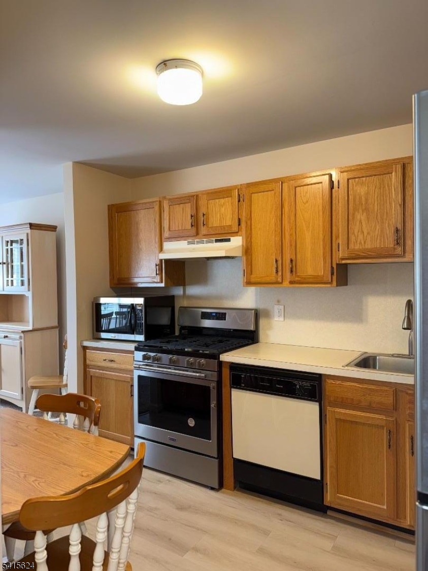 5 Chanda Court, Unit 5 Clifton, NJ 07012 - Photo 9 of 15 a kitchen with a stove a sink and a microwave
