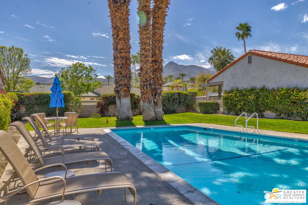 6090 East Driver Road Palm Springs, CA 92264 - Photo 4 of 29 a view of swimming pool with seating area and yard in back