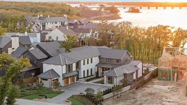 an aerial view of multiple houses with a yard