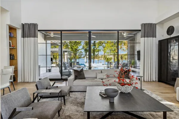 a living room with furniture and floor to ceiling windows