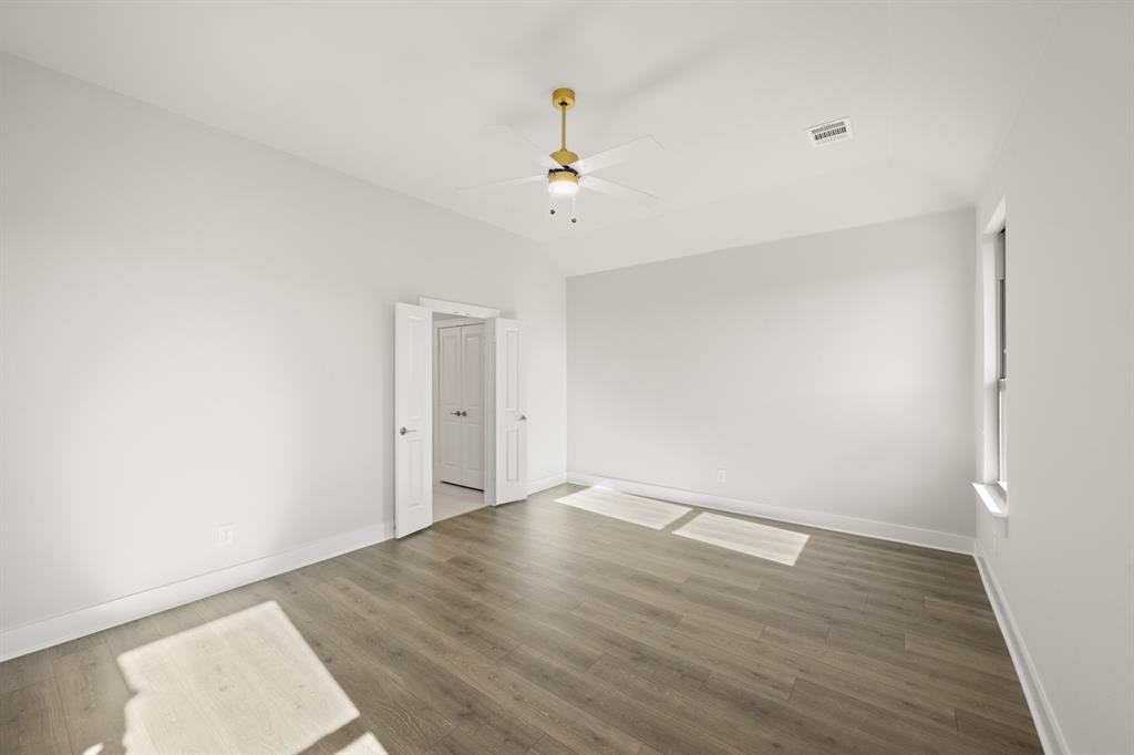 478 Red Maple Road Waxahachie, TX 75165 - Photo 20 of 27 an empty room with wooden floor ceiling fan and window