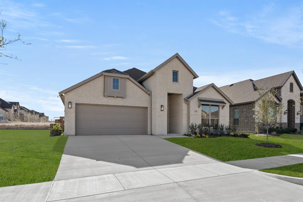 478 Red Maple Road Waxahachie, TX 75165 - Photo 2 of 27 a front view of a house with a yard and garage