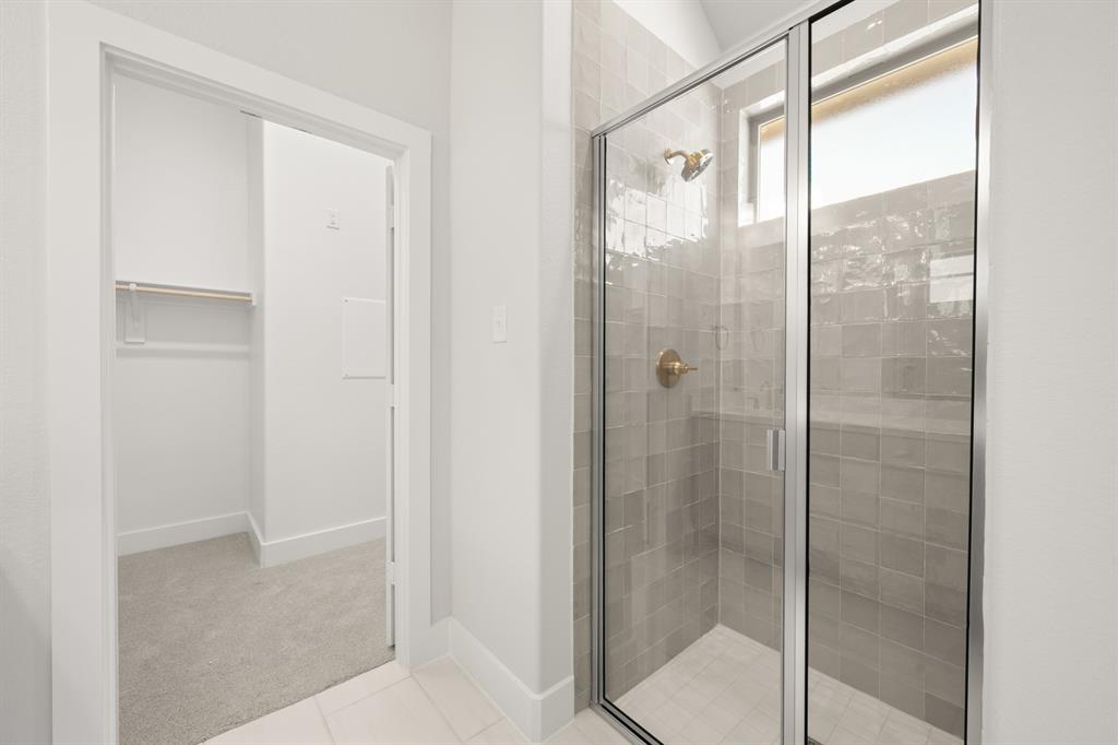 478 Red Maple Road Waxahachie, TX 75165 - Photo 22 of 27 a bathroom with a glass shower door