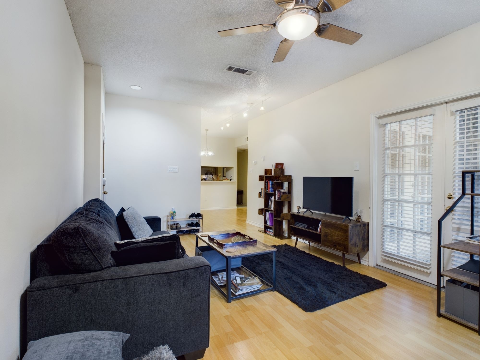 3001 Cedar Street, Unit 209 Austin, TX 78705 - Photo 3 of 17 a living room with furniture and a flat screen tv