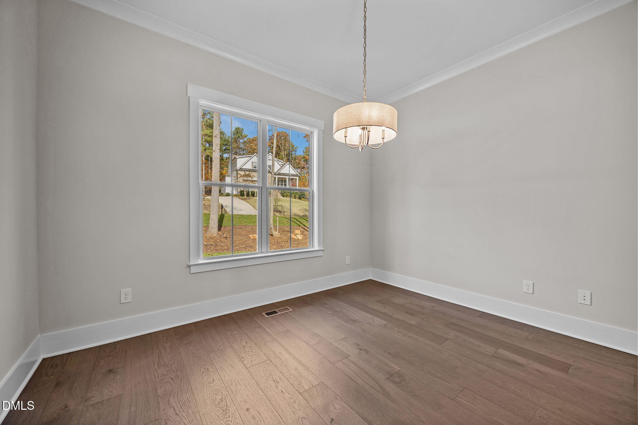 485 Chapel Ridge Drive Pittsboro, NC 27312 - Photo 13 of 74 an empty room with wooden floor exposed radiator and a window
