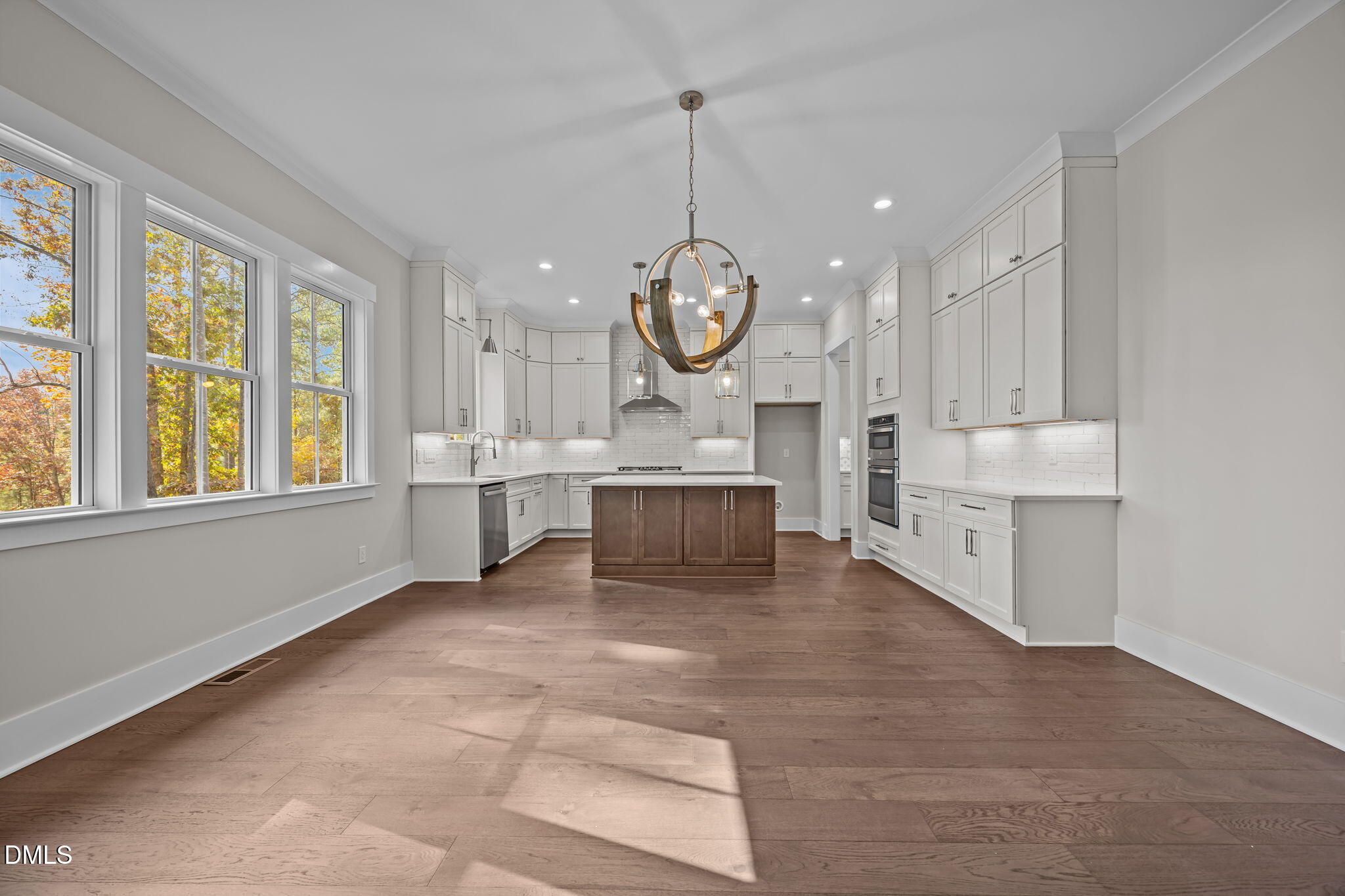 485 Chapel Ridge Drive Pittsboro, NC 27312 - Photo 30 of 74 a large white kitchen with a large window and stainless steel appliances