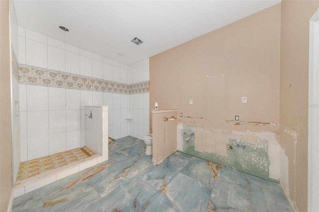 20138 Bowman Road Spring Hill, FL 34610 - Photo 25 of 40 a bathroom with a granite countertop sink and shower