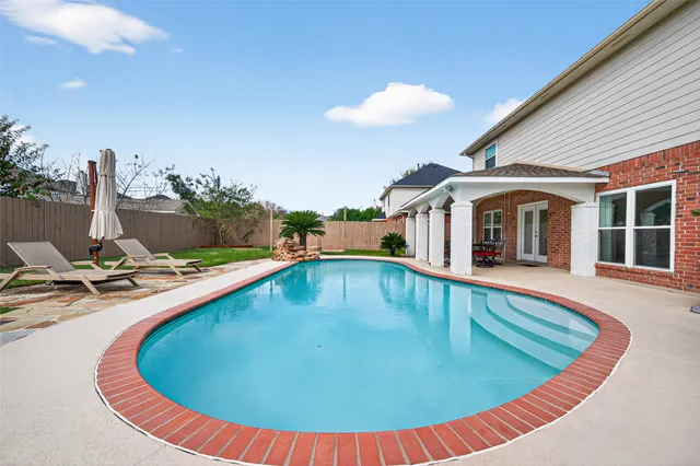 a view of a swimming pool with a patio
