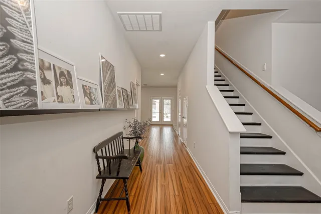 a view of entryway and hall with wooden floor