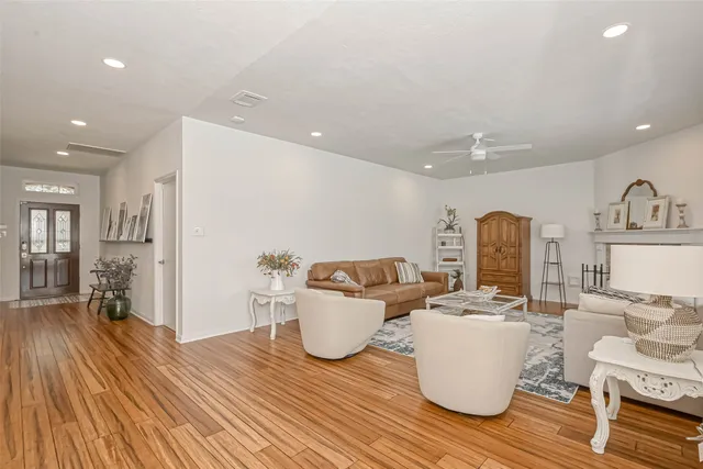 a living room with furniture and wooden floor