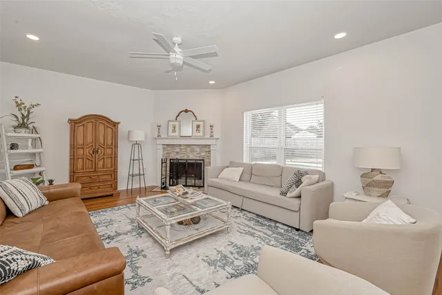 a living room with fireplace furniture a fireplace and wooden floor