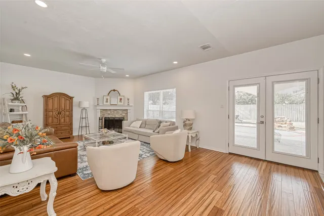 a living room with furniture ceiling fan and a window