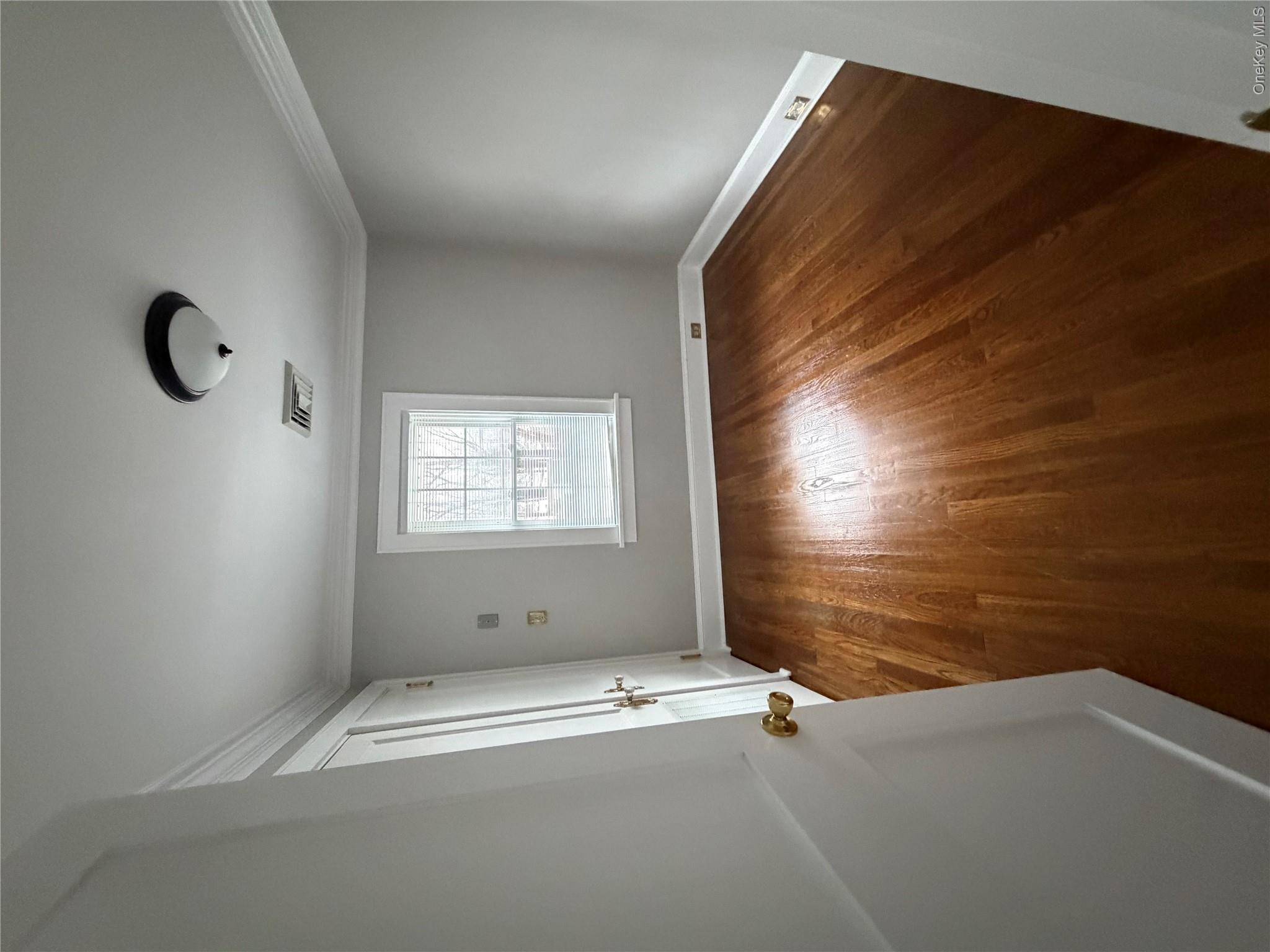 1230 Hopewell Avenue Fishkill, NY 12524 - Photo 14 of 16 an empty room with wooden floor and windows