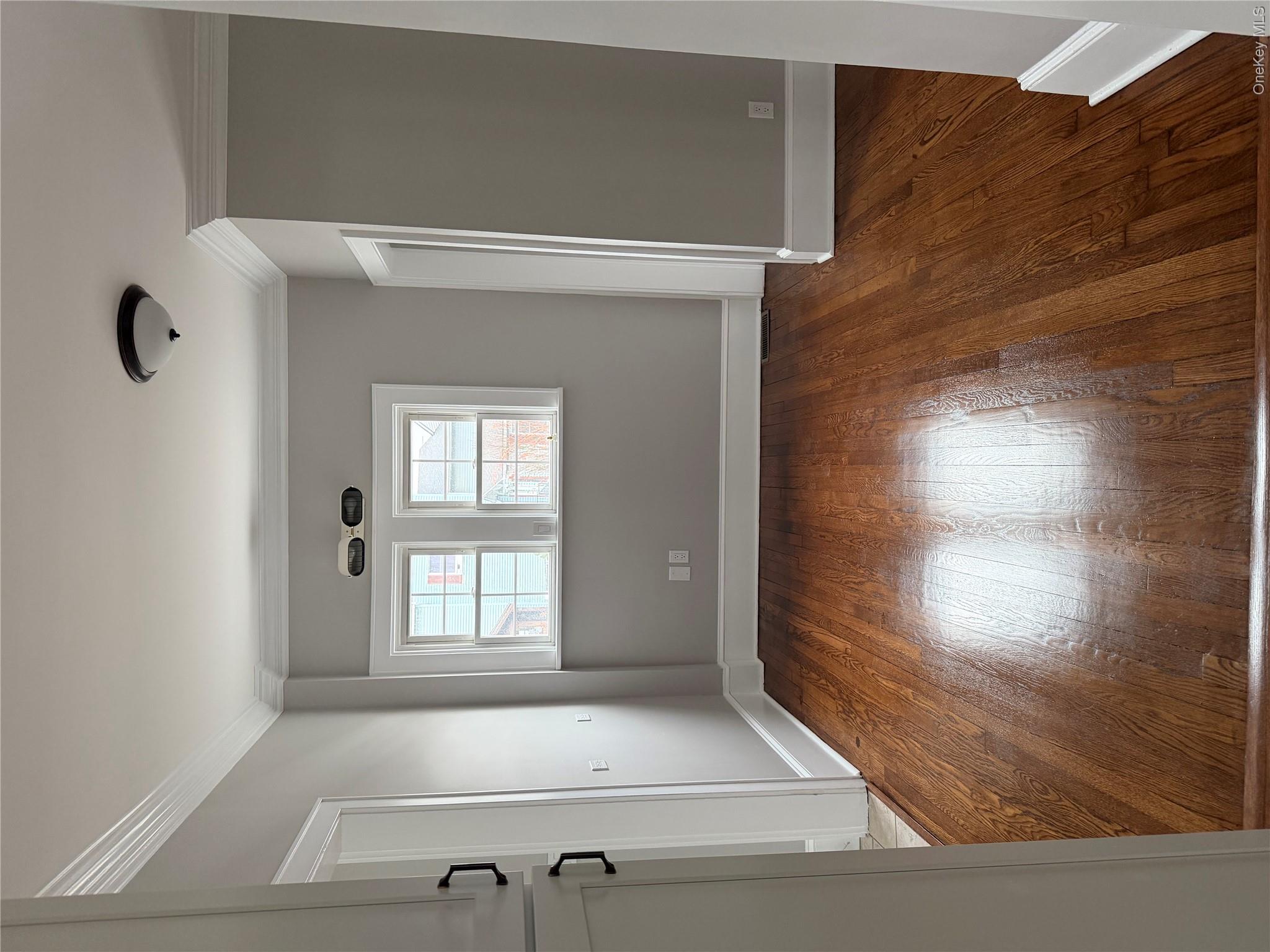 1230 Hopewell Avenue Fishkill, NY 12524 - Photo 4 of 16 an empty room with wooden floor and windows