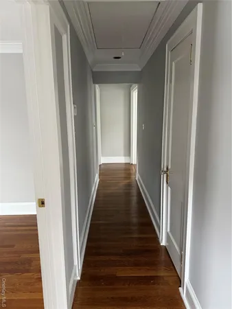 a view of a hallway with wooden floor and entryway