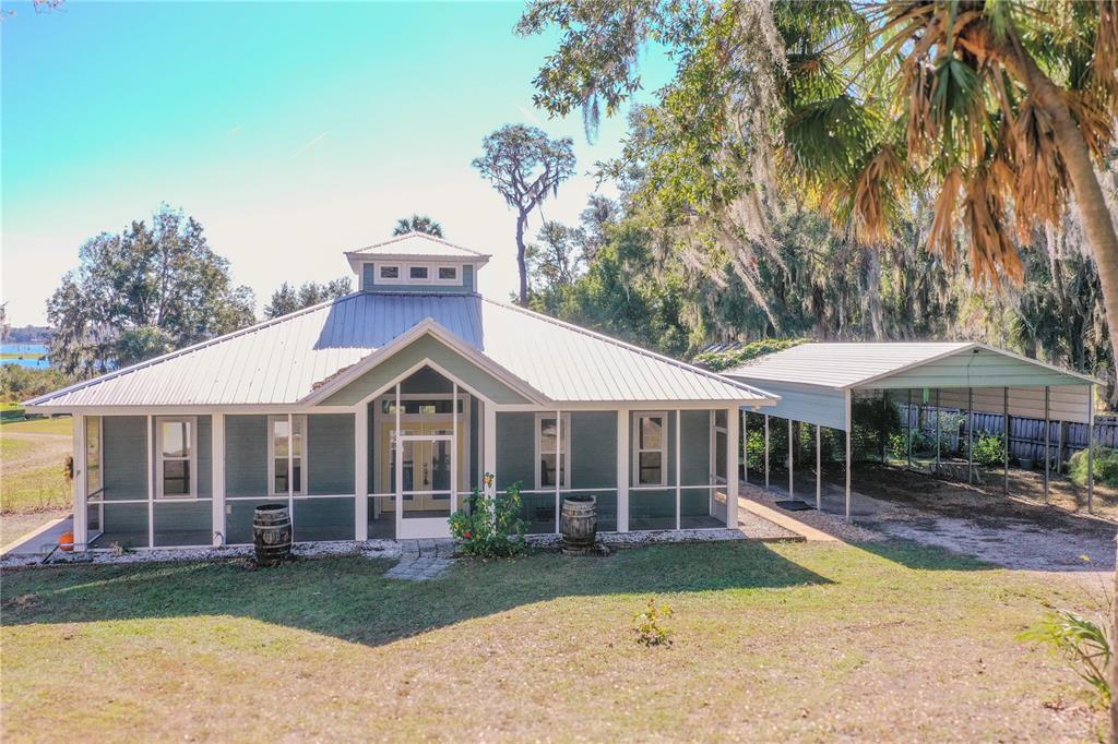 19151 Southeast 135th Court Dunnellon, FL 34431 - Photo 1 of 65 a front view of a house with a garden and porch